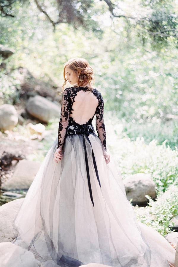 Black lace bridal gown with V-neck and flowing A-line skirt.