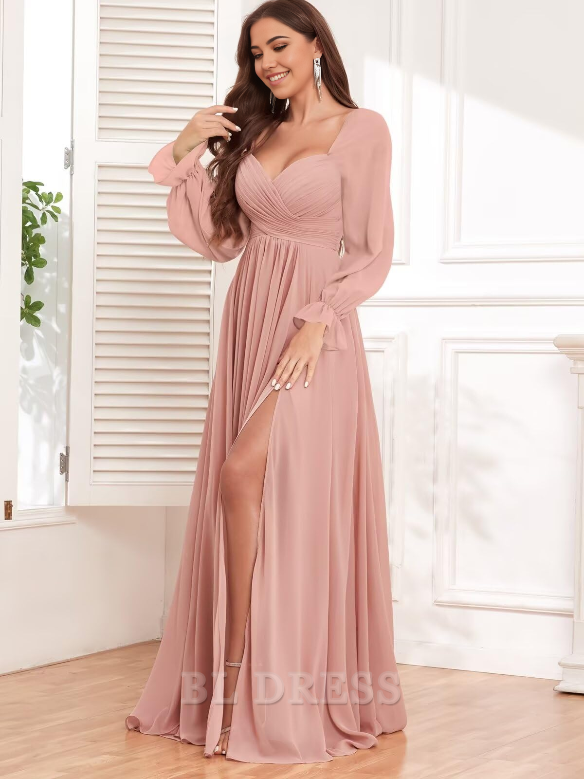 Side view of the pleated A-line chiffon gown, showing the long sleeves and thigh-high slit.