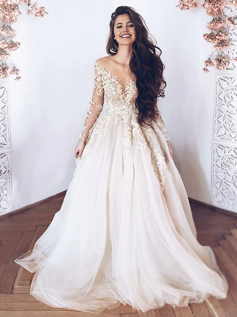 Champagne A-line prom and wedding dress with lace appliques and long sleeves.