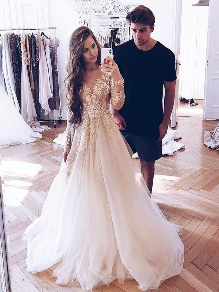 Back view of the champagne A-line lace tulle long sleeve dress.