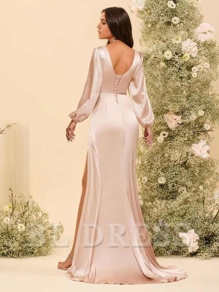 Close-up of the pleated satin fabric and V-neckline of the formal gown.