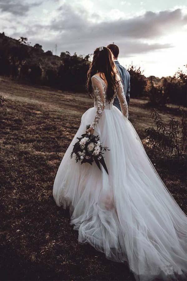 Close-up of the V-neckline and intricate lace appliques on the bodice of the wedding dress.