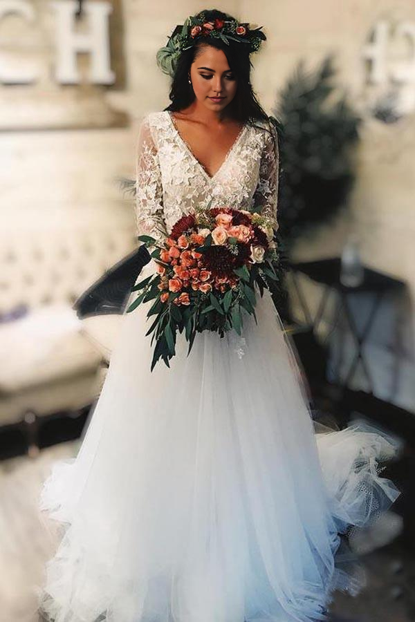 A-line tulle wedding dress with long sleeves and lace applique.
