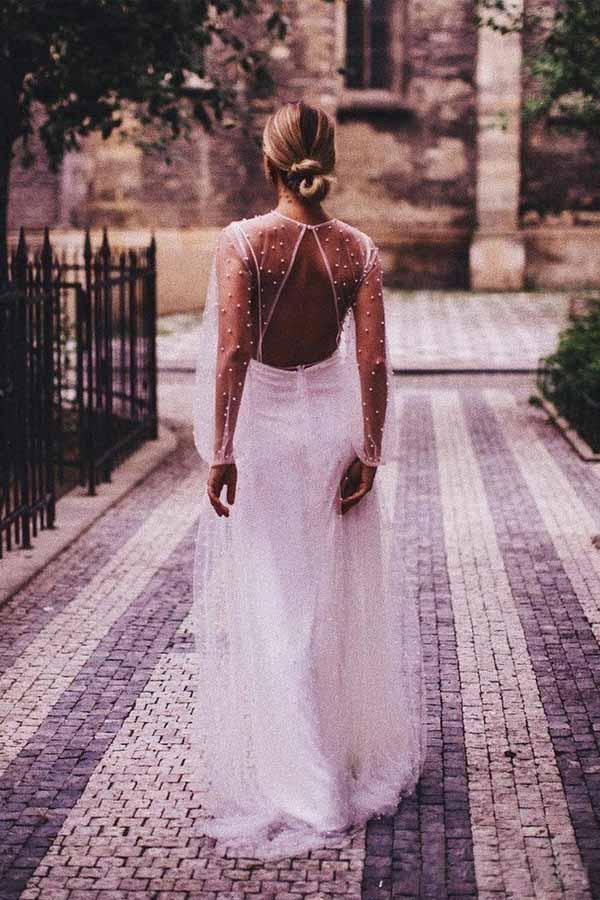 Close-up of the see-through tulle and pearl embellishments on the wedding dress.