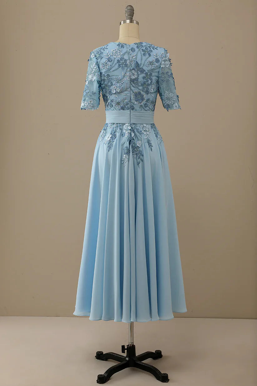 Detail of the V-neckline and appliques on the A-line dress.