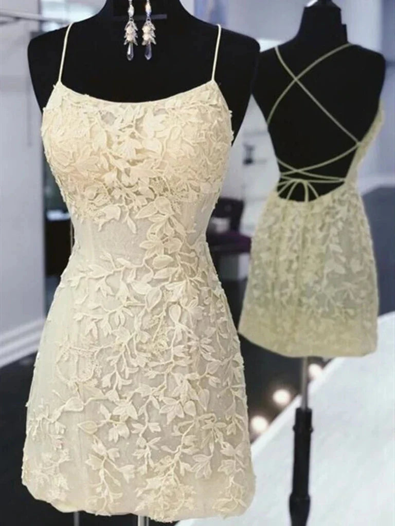 Woman wearing an elegant A-line short lace dress with V-neck and open back.