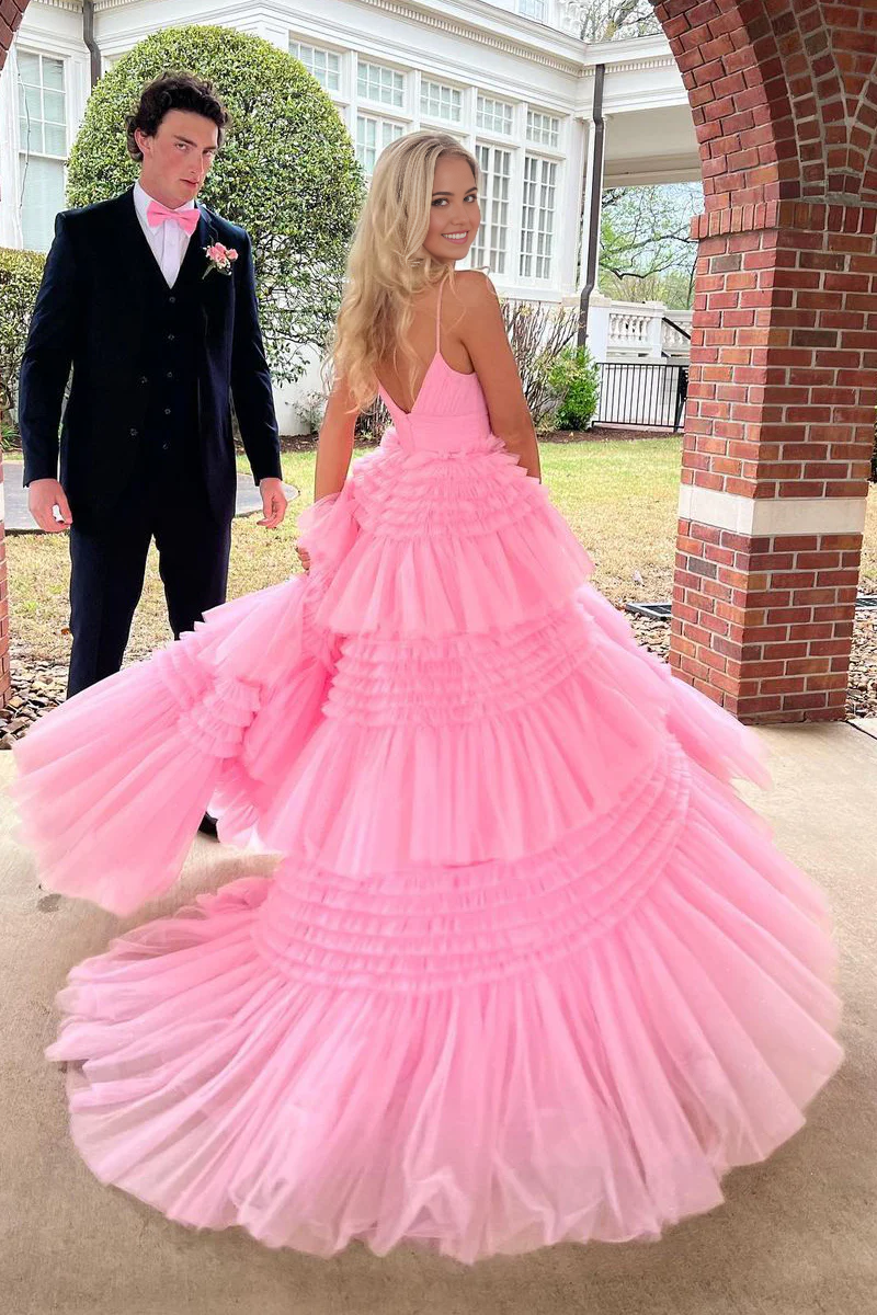 Back view of a model in a pink A-line V-neck tulle ball gown with a slit.