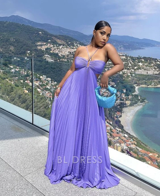 Model wearing a long purple A-line V-neck pleated formal dress.