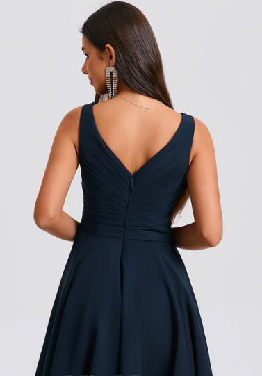 Model posing in an elegant A-line V-neck short pleated dress.