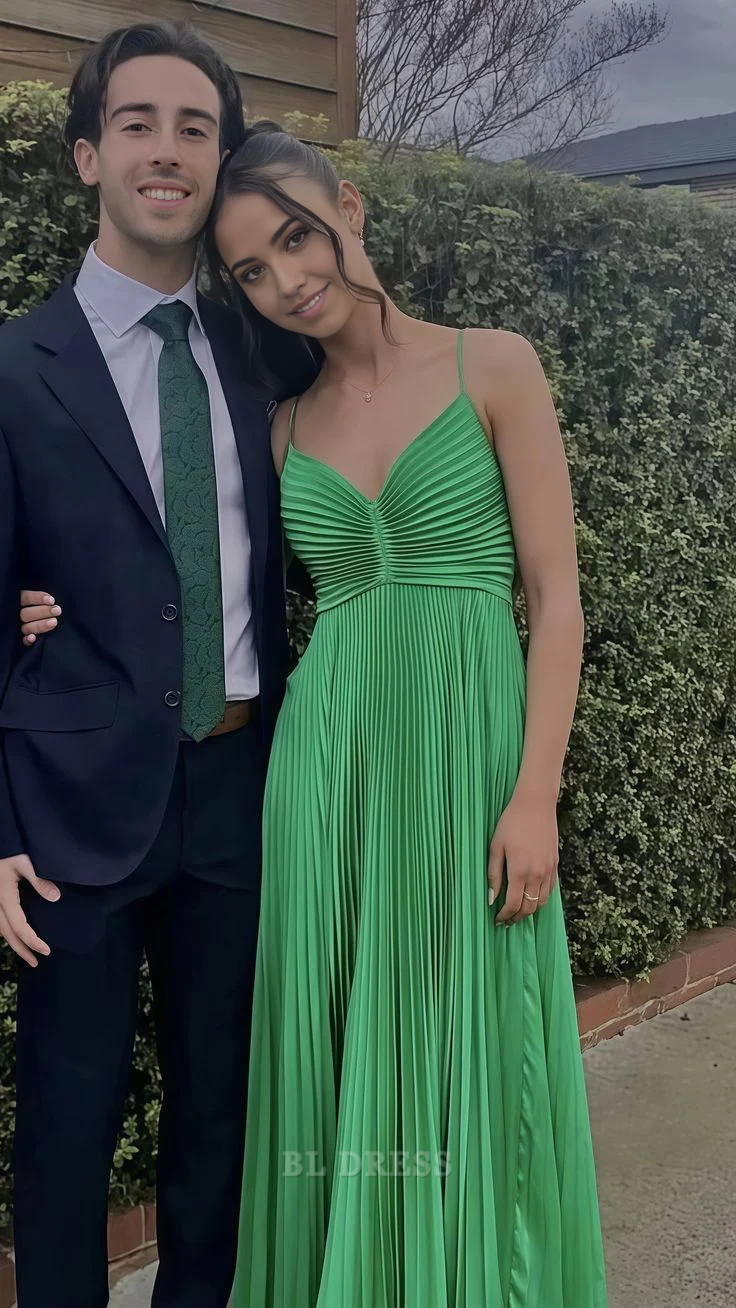 Side view of a V-neck pleated prom dress with flowing A-line skirt.