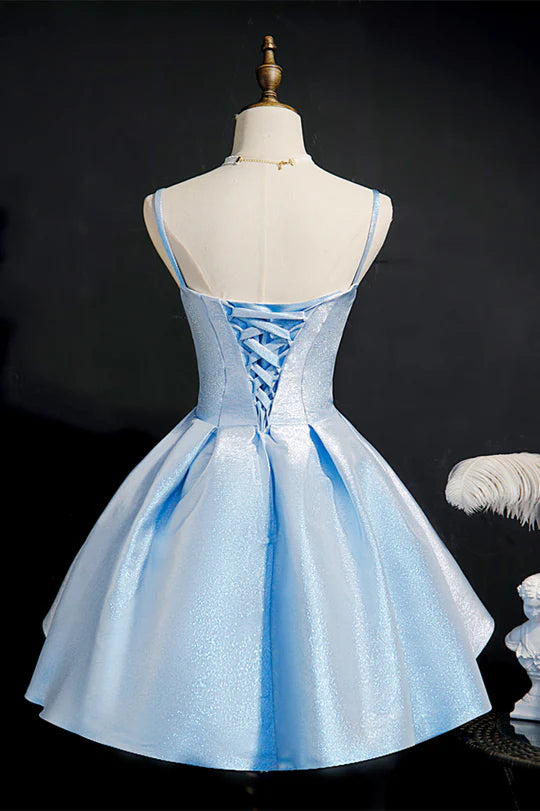 Back view of blue pleated A-line dress with delicate straps.