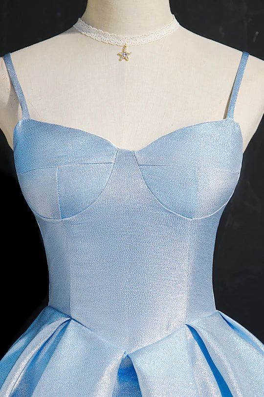 Side profile of a woman wearing a blue V-neck pleated dress.