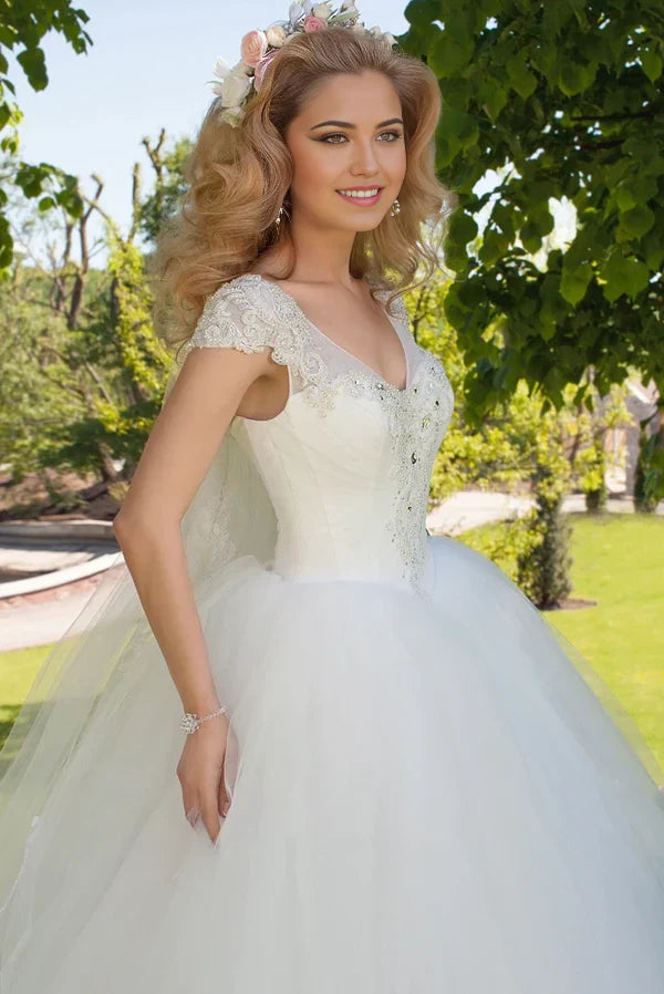 Back view of the flowing tulle ball gown wedding dress, showcasing its voluminous skirt.