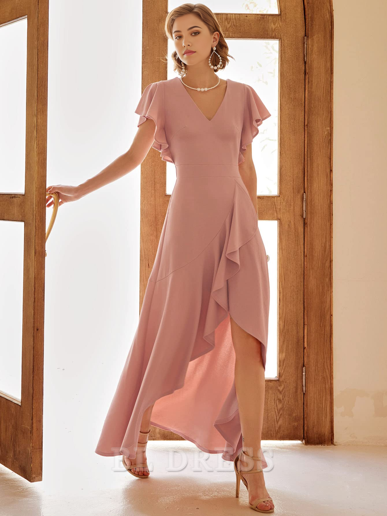 Close-up of ruffle and split detail on a formal A-line dress.