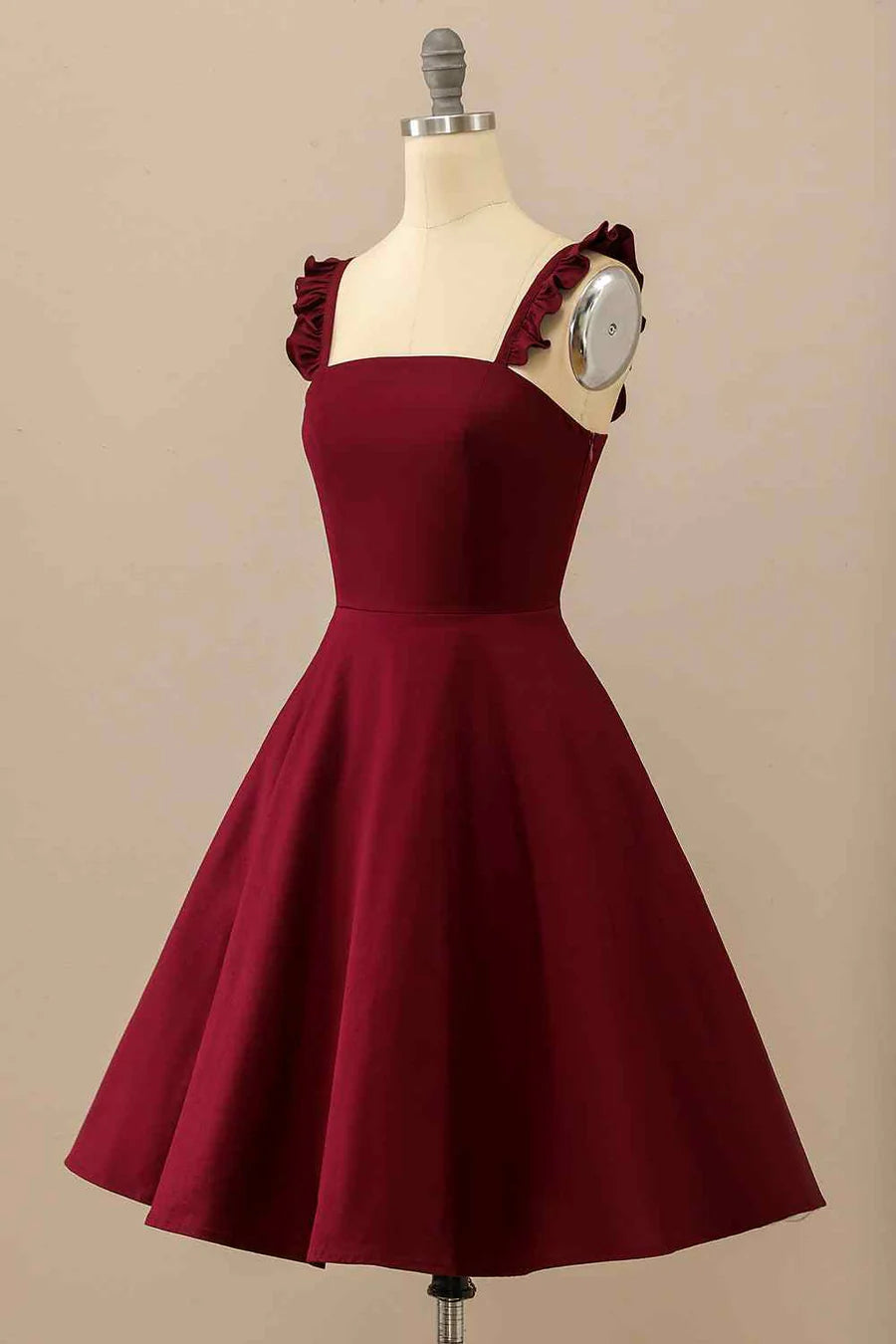 Close-up of ruffle straps on A-line satin mini homecoming dress.