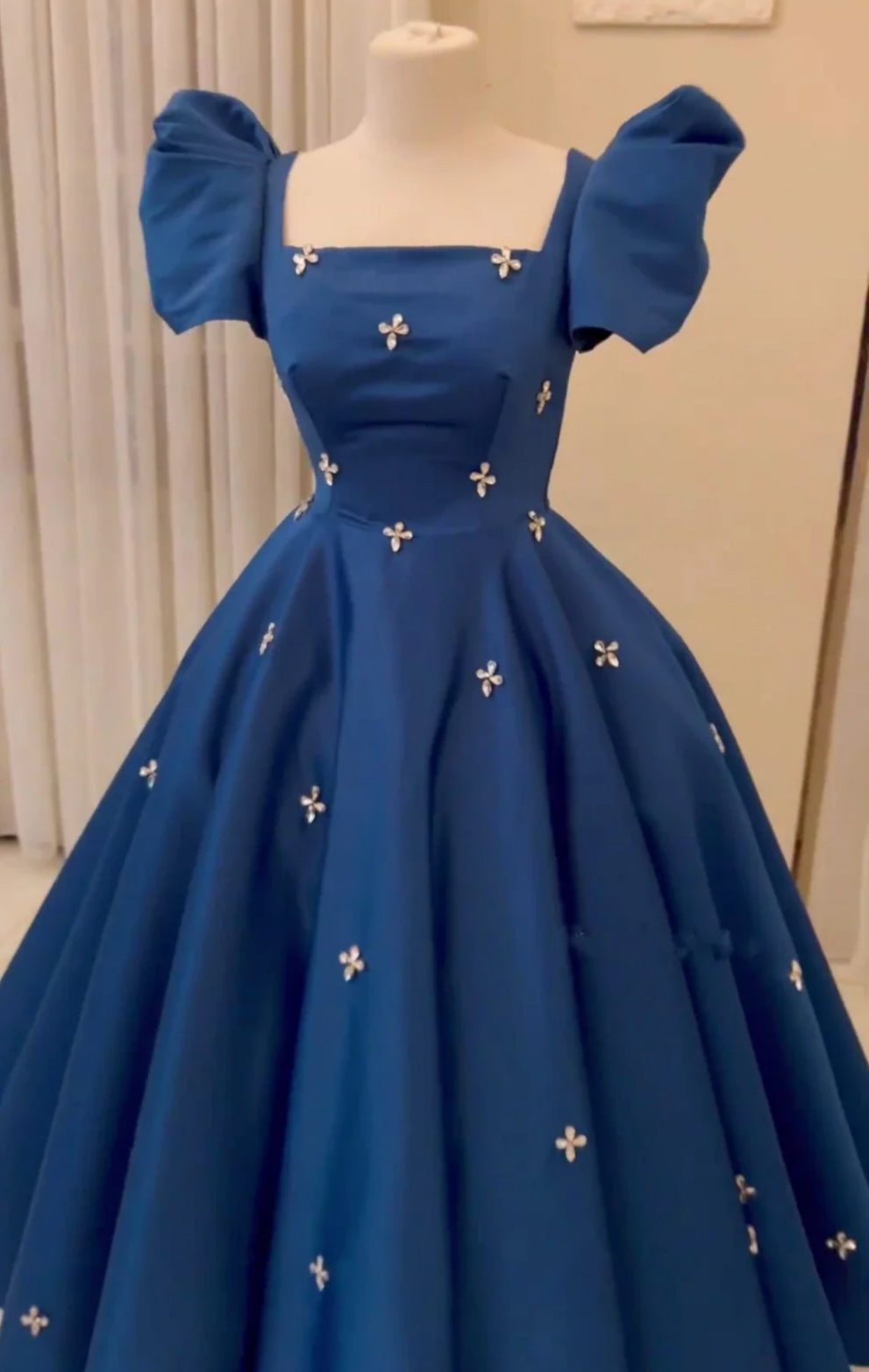 Model showcasing the back detail of the A-line V-neck satin formal dress.