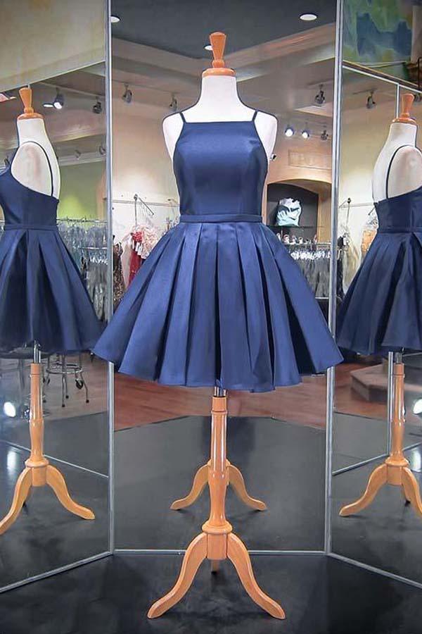 Navy blue A-line satin homecoming dress with spaghetti straps.