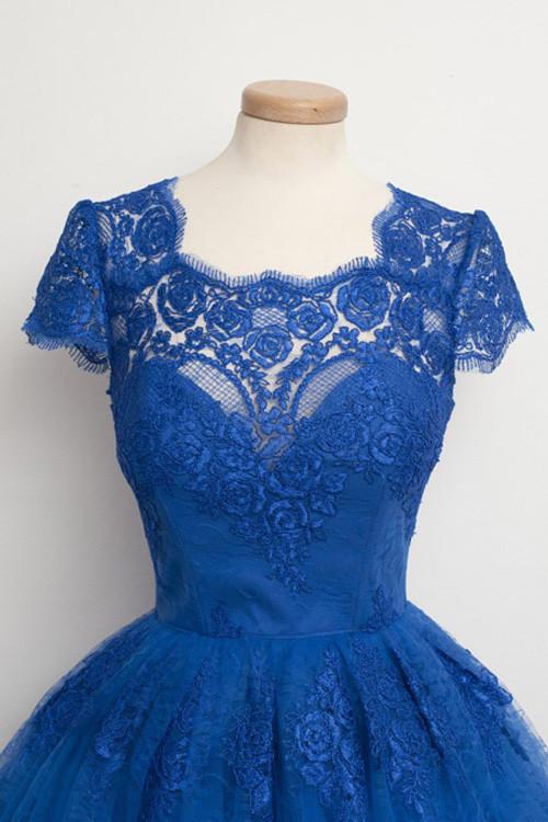 Close-up of the scalloped V-neckline and A-line skirt of the dress.