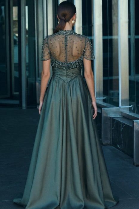 Back view of the dark green satin A-line dress, showing the elegant silhouette.