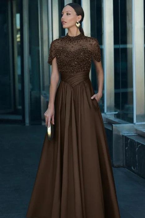 Detail of the V-neckline and beaded embellishments on the dark green dress.