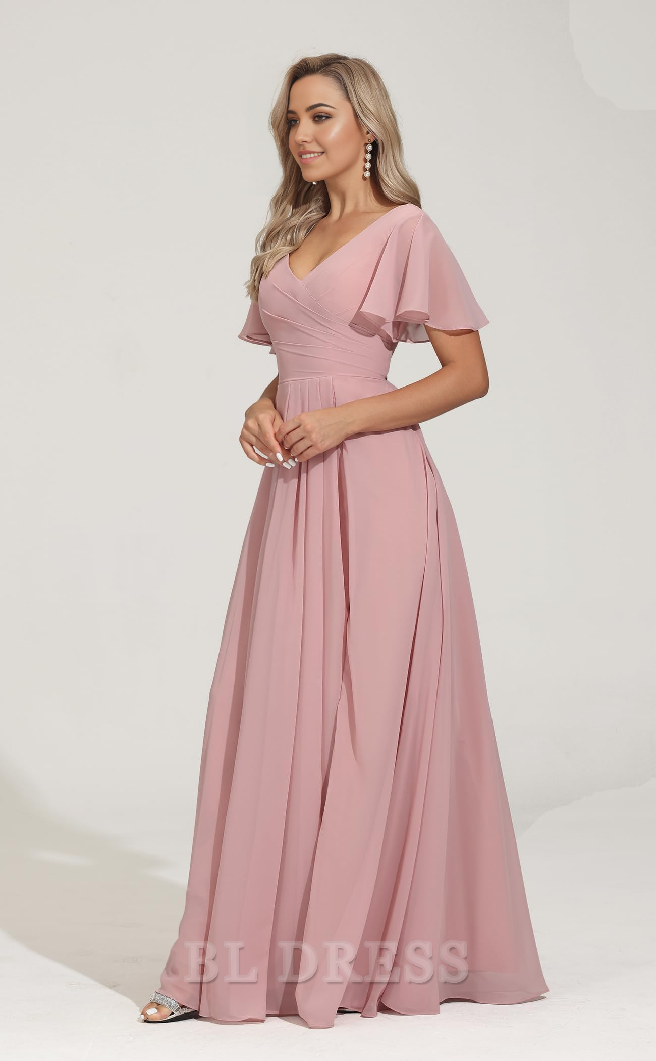 Close-up of the V-neckline and short pleated sleeves on the chiffon dress.