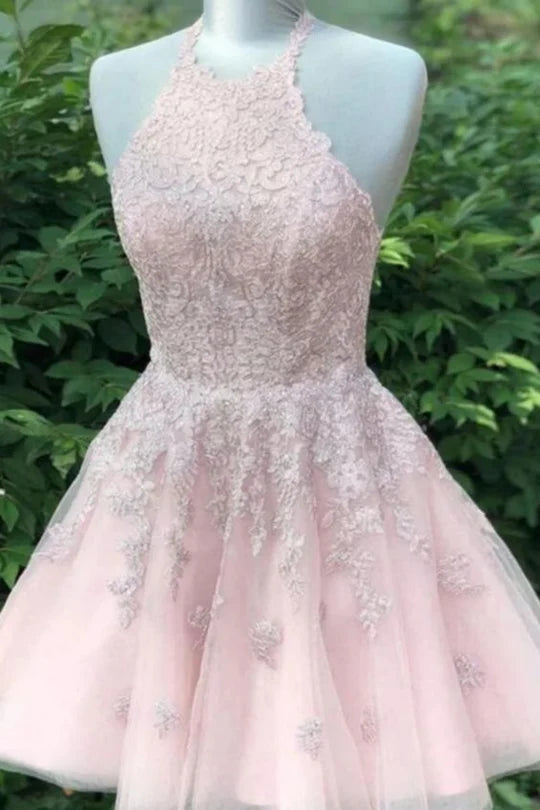 Model wearing a short A-line V-neck prom dress with appliques.