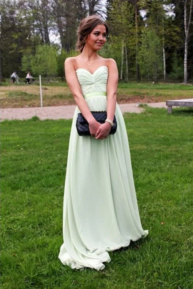 Woman wearing an elegant A-line V-neck chiffon prom dress.