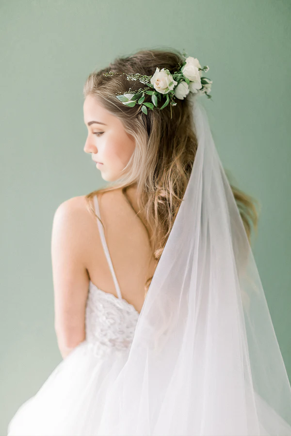 Side view of bride in A-line V-neck wedding dress.