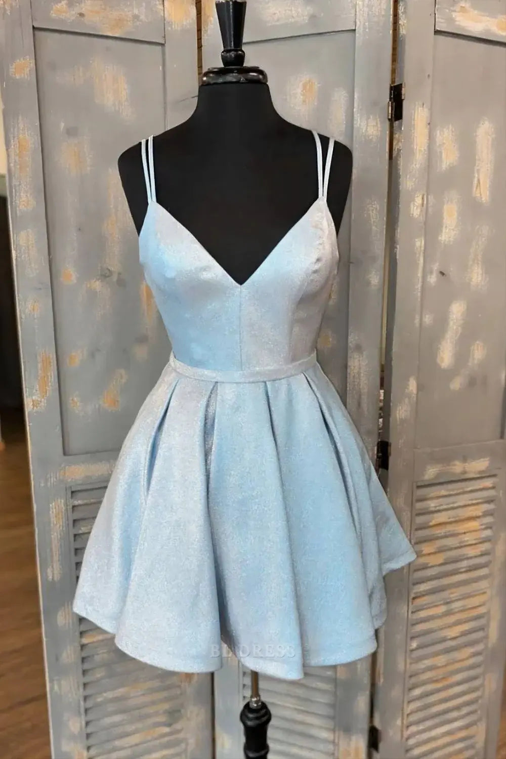 Woman wearing a dark blue A-line V-neck mini dress.