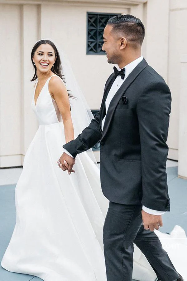 Back view of an ivory satin A-line wedding gown.