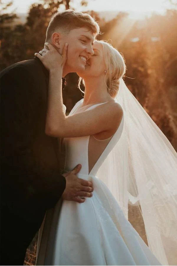Ivory satin wedding dress with elegant A-line silhouette.