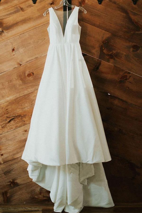 Close-up of the V-neck and satin fabric on a wedding gown.