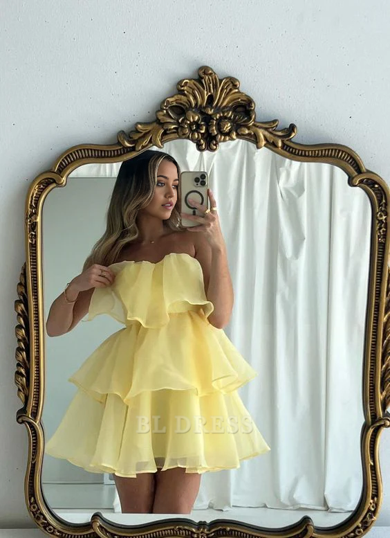 Elegant yellow A-line short dress with V-neck and tiered skirt.
