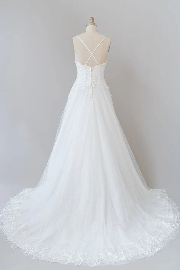 Close-up of delicate applique on tulle fabric of wedding dress.