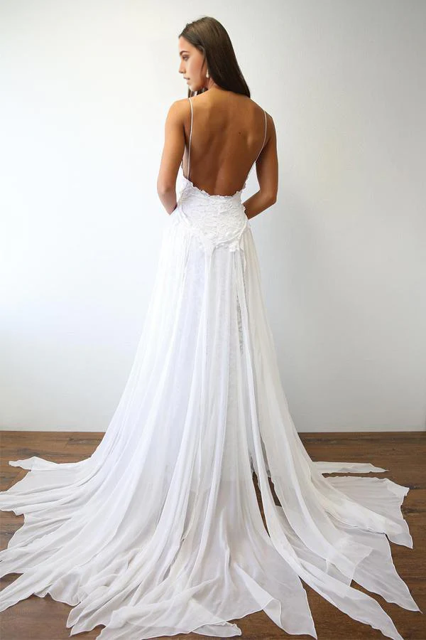 Close-up of the V-neck and delicate spaghetti straps of the white wedding dress.