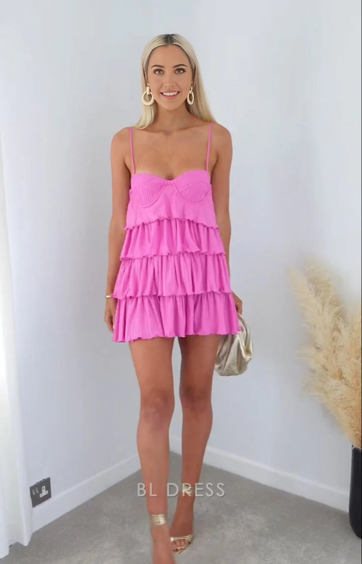 A full-length view of a woman in the elegant A-line tiered dress with spaghetti straps.