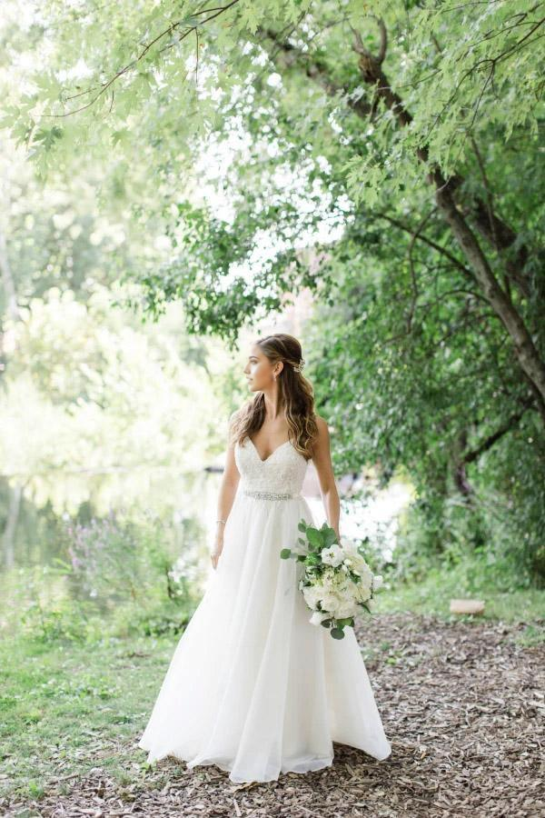Elegant A-line V-neck wedding dress with spaghetti straps.