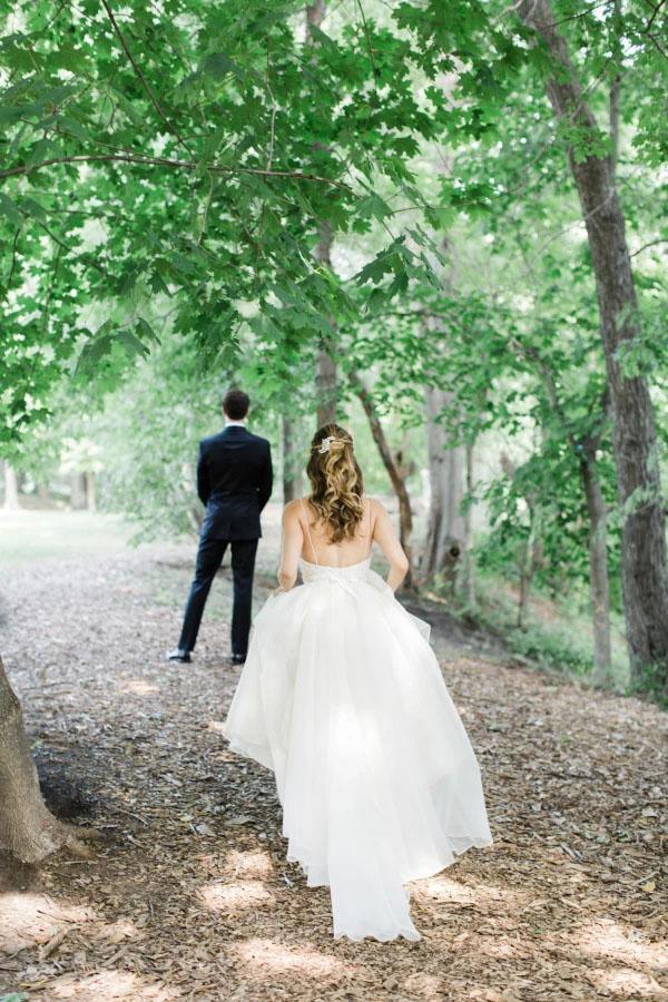 Full view of a white A-line bridal gown with V-neck.