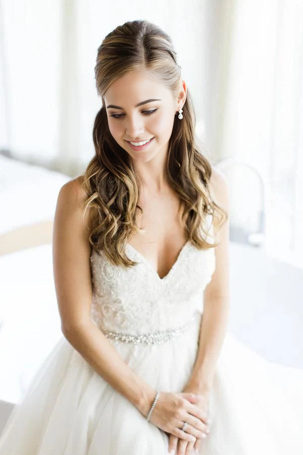 Romantic spaghetti strap wedding dress in A-line silhouette.