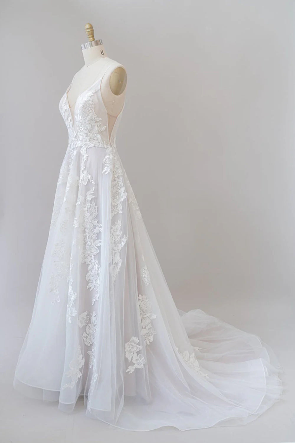 A-line spaghetti strap wedding dress with lace appliques and tulle skirt.