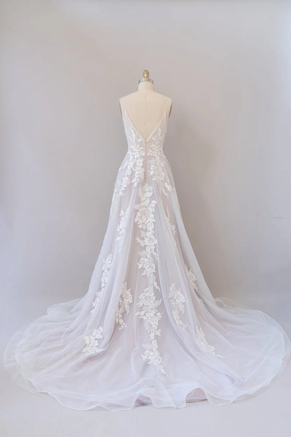 Back view of A-line wedding dress showing backless design and flowing tulle.