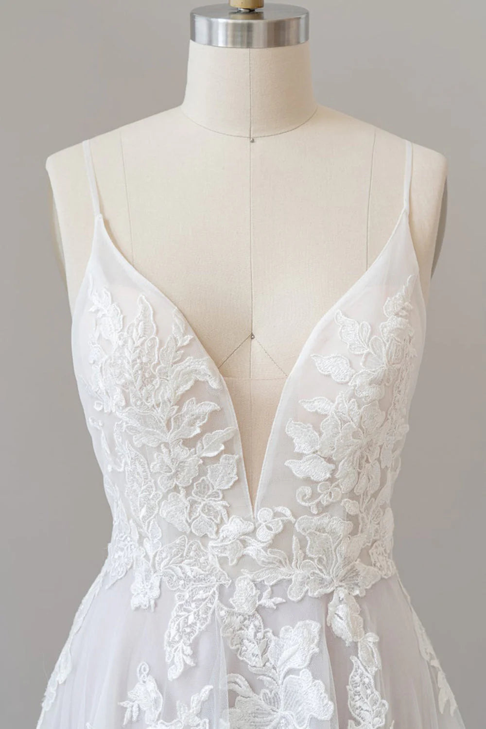 Close-up of lace appliques on the bodice of the A-line wedding dress.