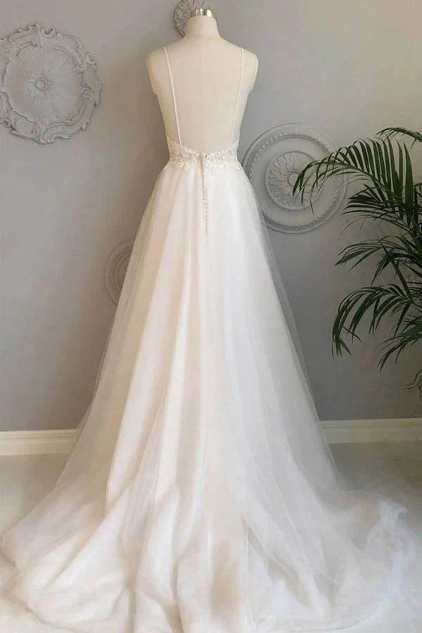Back view of A-line lace wedding gown with delicate train.