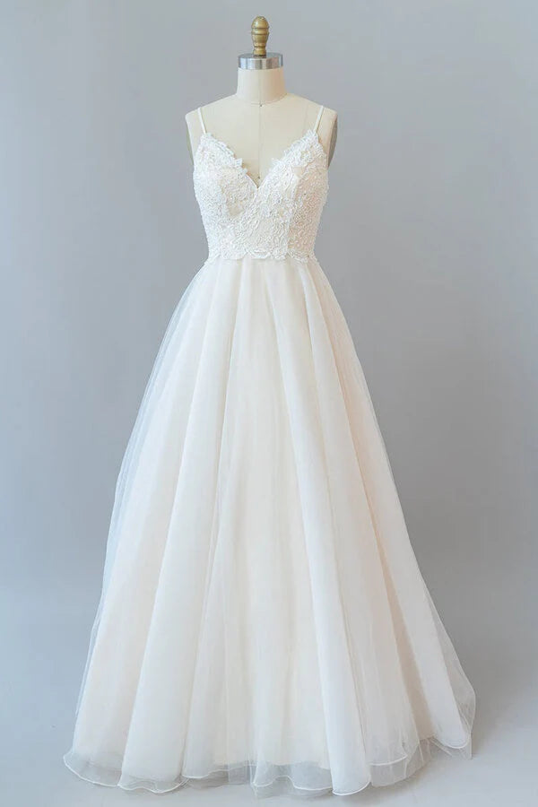A-line lace and tulle backless wedding dress with spaghetti straps.