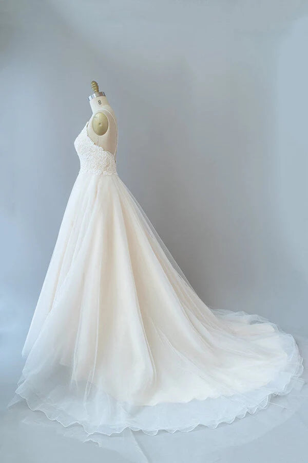 Full length view of the tulle skirt and A-line silhouette of the wedding dress.
