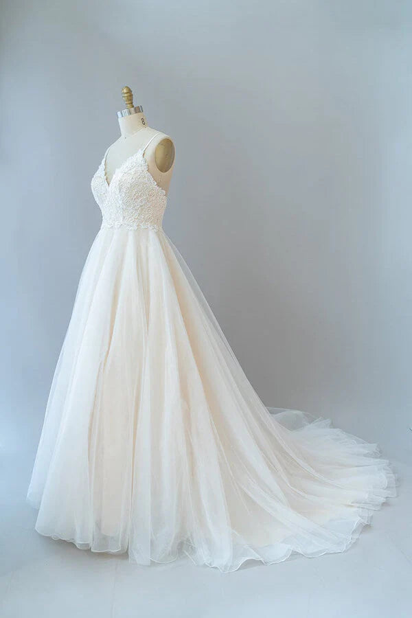 Bride wearing an A-line V-neck wedding dress with lace details.
