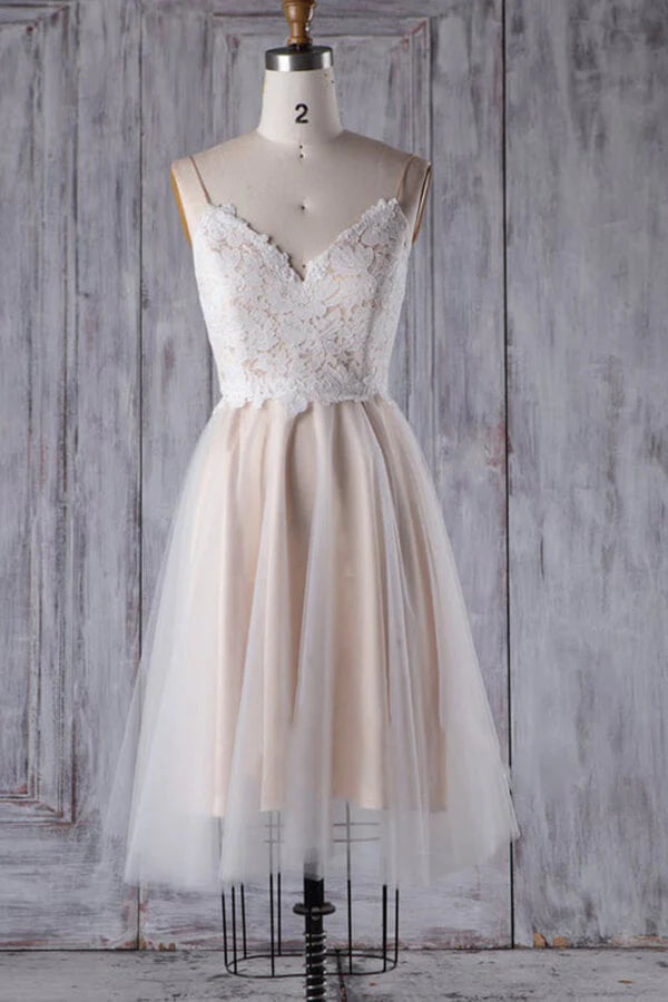 A-line short wedding dress with spaghetti straps, lace bodice, and tulle skirt.