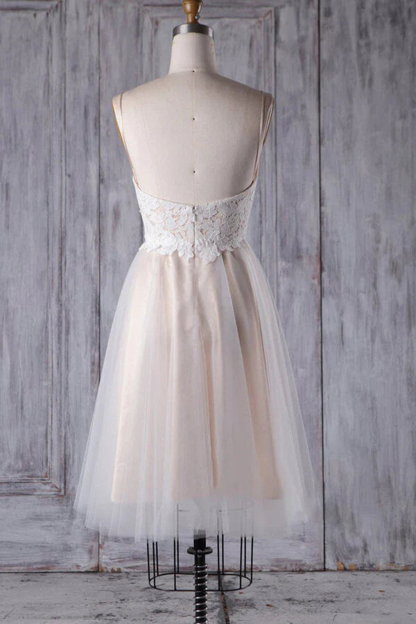 Back view of a short A-line wedding dress with delicate lace details.