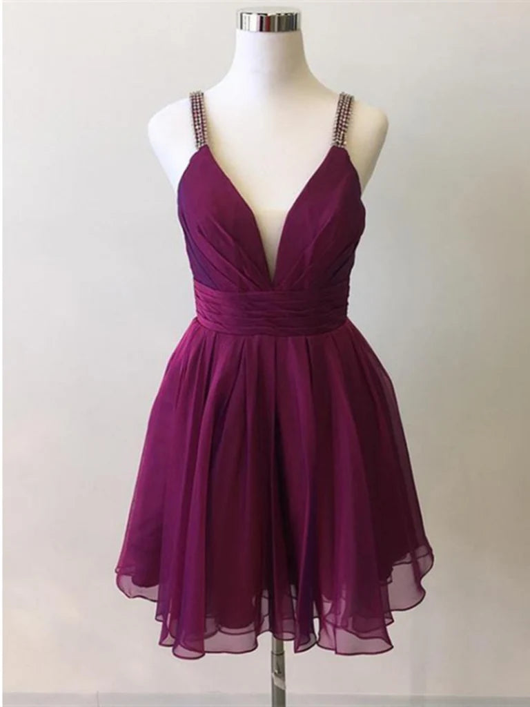 Model wearing a long purple A-line prom dress with spaghetti straps and V-neck.