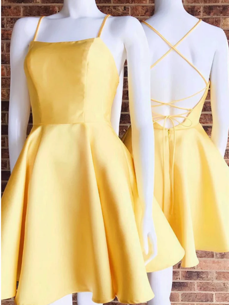 Model wearing a short A-line satin dress with spaghetti straps and V-neck, suitable for prom or homecoming.